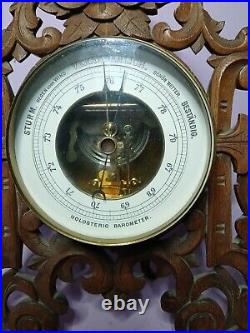 An Antique Blackforest style hand carved German Barometer