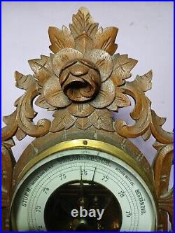 An Antique Blackforest style hand carved German Barometer