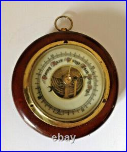 Vintage barometer round wood case metal face fancy wording on front