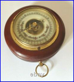 Vintage barometer round wood case metal face fancy wording on front